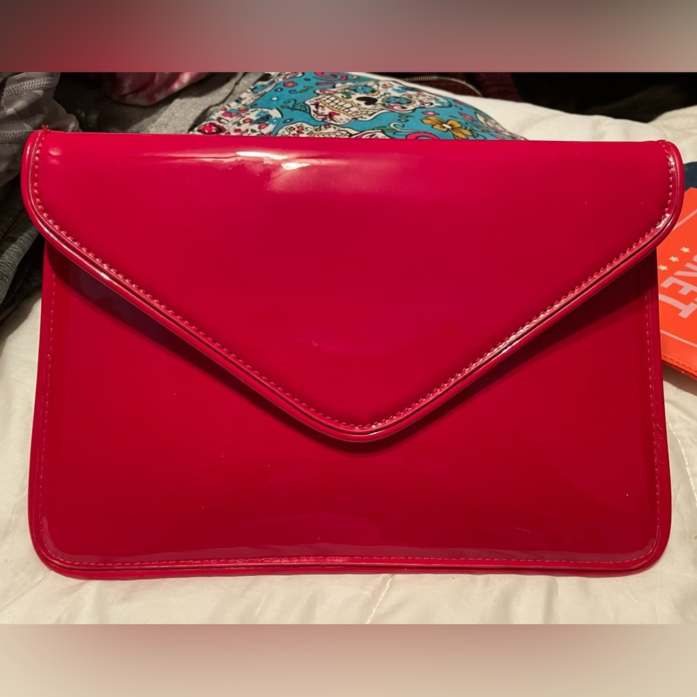 Red patent leather clutch purse.